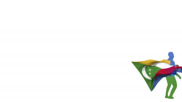 Comores joueur de football avec un drapeau en arrière-plan donne un coup de pied à une balle tordue et coups de pied à travers lui-même. La balle vole vers l'écran. Transparence du canal Alpha pour la superposition .