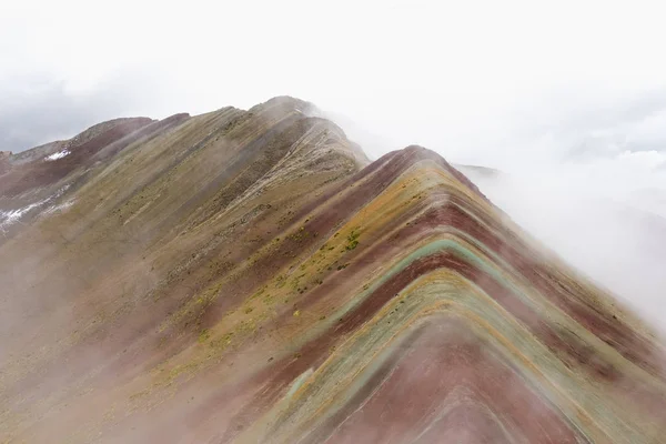 Famous mountains in Peru, Rainbow Mountains. Mountains of the color of the rainbow. Red mountains. Landscape in foggy weather