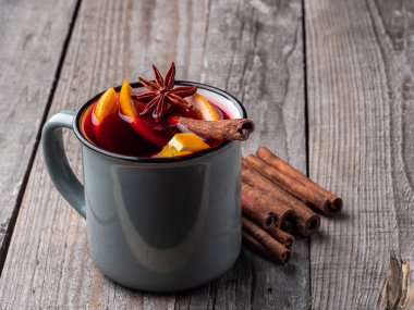 Tarçın çubukları ve ahşap bir masa üzerinde yıldız anason ile Mulled şarap.