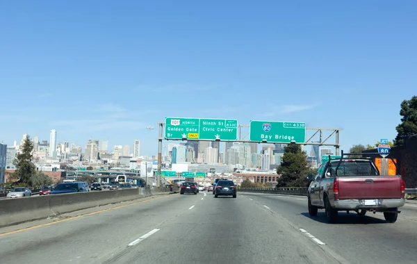 Light traffic moving into San Francisco on Highway 101. Sign showing Bay and Golden Gate Bridge exits. Horizontal.