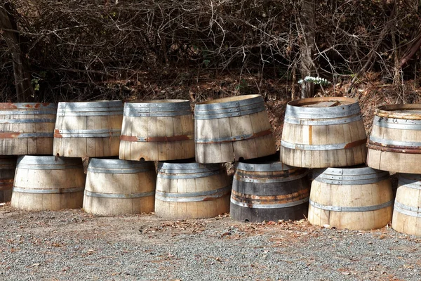Empty wine casks selling as wood planter boxes.