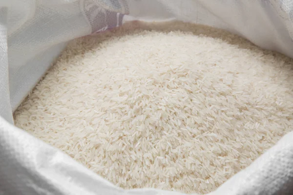 Weißer Reis im Leinensack - Archivbild lizenzfreie Stockfotos