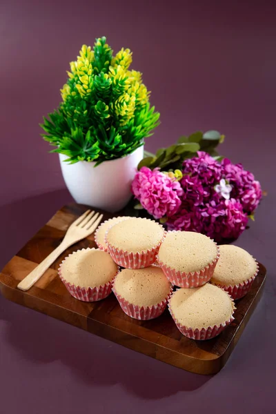 Ancient egg cakes in paper cup with purple background - stock photo