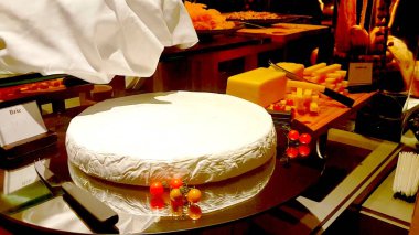 Geleneksel bir dükkanda büyük bir peynirin fotoğrafı gösterildi.