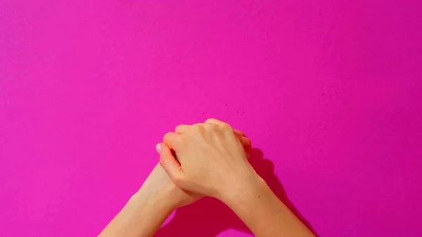Widok Góry Dłoni Kobiety Która Pociera Rękami Różowe Tło — Zdjęcie stockowe