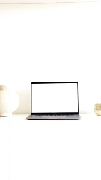 The verticale photo of a laptop on a white background