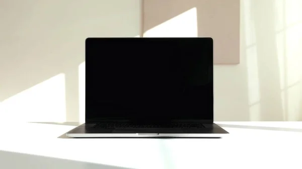 A photo of a black laptop on a white background