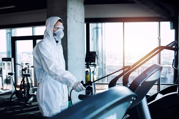 Gym Disinfection Fitness Equipment Man White Protection Suit Disinfecting Spraying — Stock Photo, Image