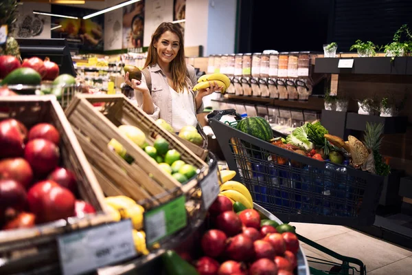 Persona Femminile Che Tiene Frutta Supermercato Sorride Carrello Accanto Alla — Foto Stock