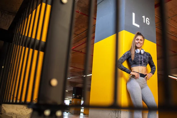 Portrait of strong and sexy female athlete looking at camera. Sport and fitness.