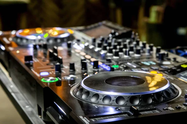 Professional party dj sound mixer controller. Play & remix music tracks at party or concert with modern audio equipment.