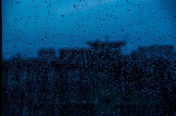 dark blue Texture Raindrops on window glass for rain, photo, blurred background, drizzle