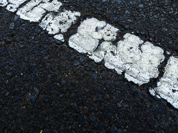 Road traffic paint on the asphalt surface