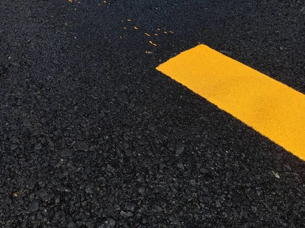 Road traffic paint Yellow on the asphalt surface