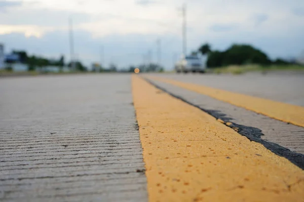 Road traffic paint Yellow on the concrete  surface