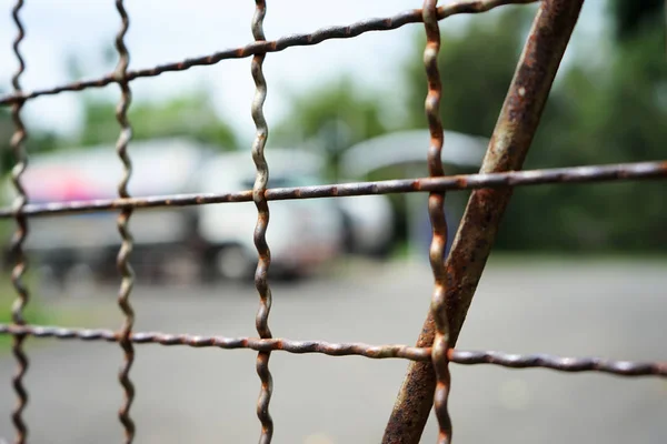 Steel mesh fence with blurred background