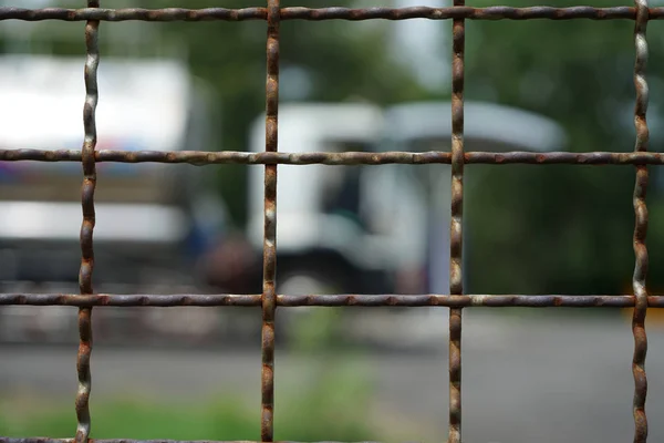 Steel mesh fence with blurred background