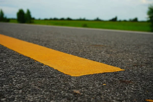 Road traffic paint Yellow on the asphalt surface