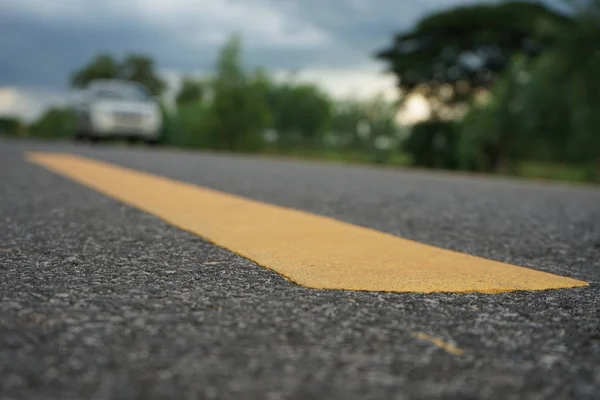 Road traffic paint Yellow on the asphalt surface