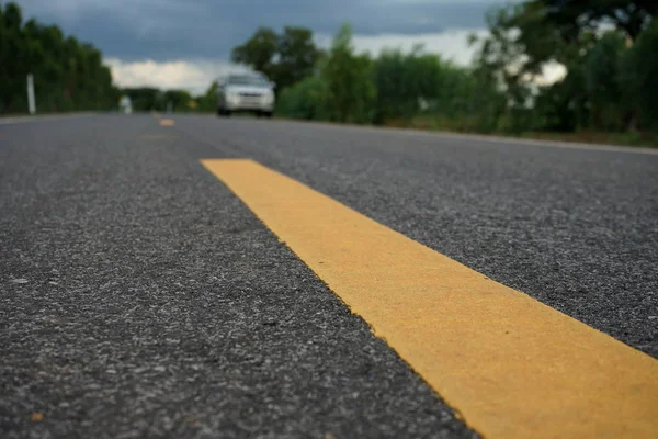 Road traffic paint Yellow on the asphalt surface