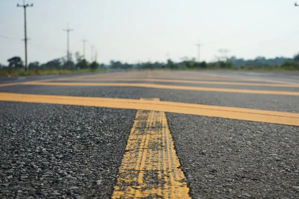 Road traffic paint Yellow on the asphalt surface