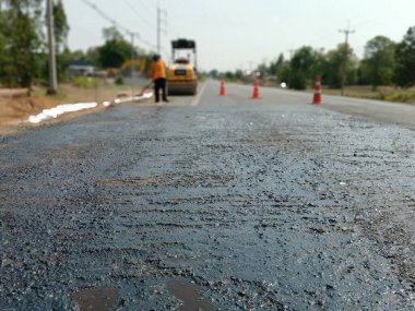 Repair work of roads for safe traffic(prime coat) clipart