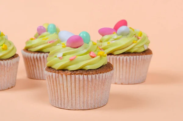 Bright pistachio Easter cupcake with decorations close up