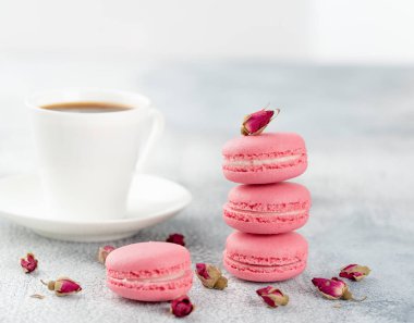 Pembe macaroons kurutulmuş çiçek tomurcukları ve kahve. Pastel renkli