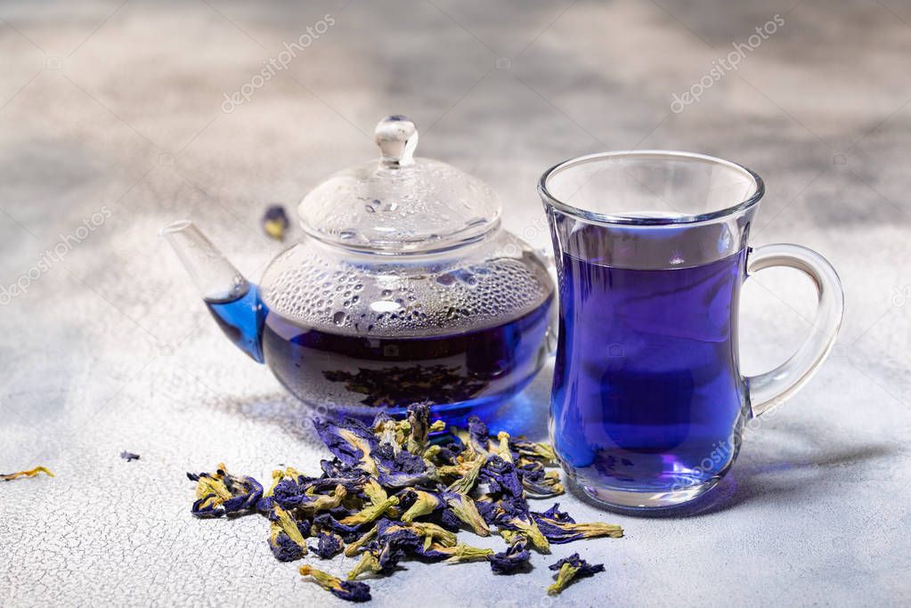 Organic blue tea Anchan, Clitoria, Butterfly Pea in glass cup and glass teapot.