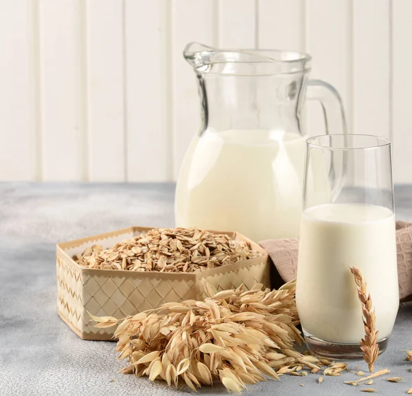 The concept of a vegetarian diet. Oat milk in the glass with jug — Stock Photo, Image