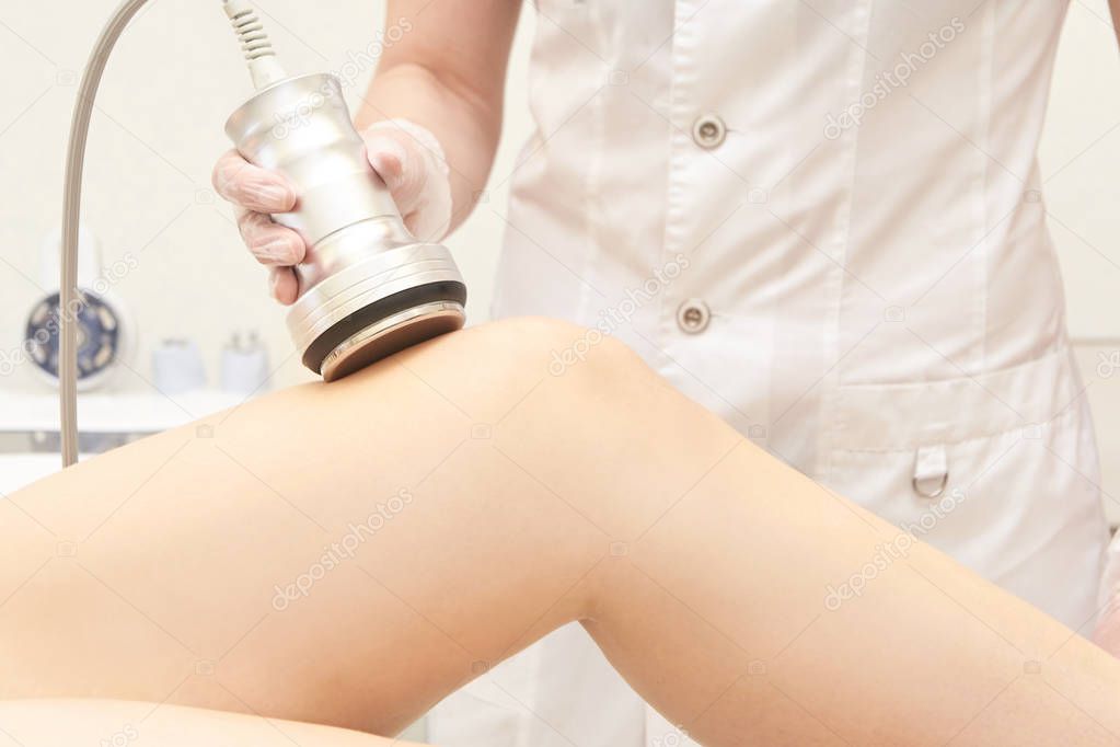 Body cavitation treatment. Ultrasound care to fat reduction. Beauty ultrasonic massage therapy at salon. Anti cellulite.