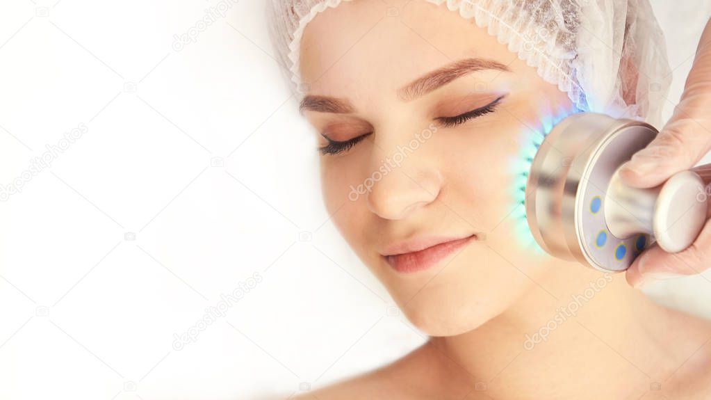 Woman cosmetology procedure. Light face treatment. Medical skin repair. Anti wrinkle. Color skincare.