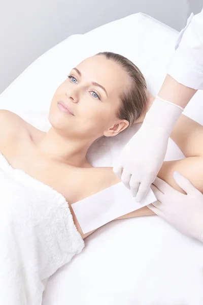 Waxing woman leg. Sugar hair removal. laser service epilation. Salon wax beautician procedure.