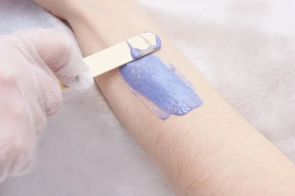 purple wax arm depilation.
