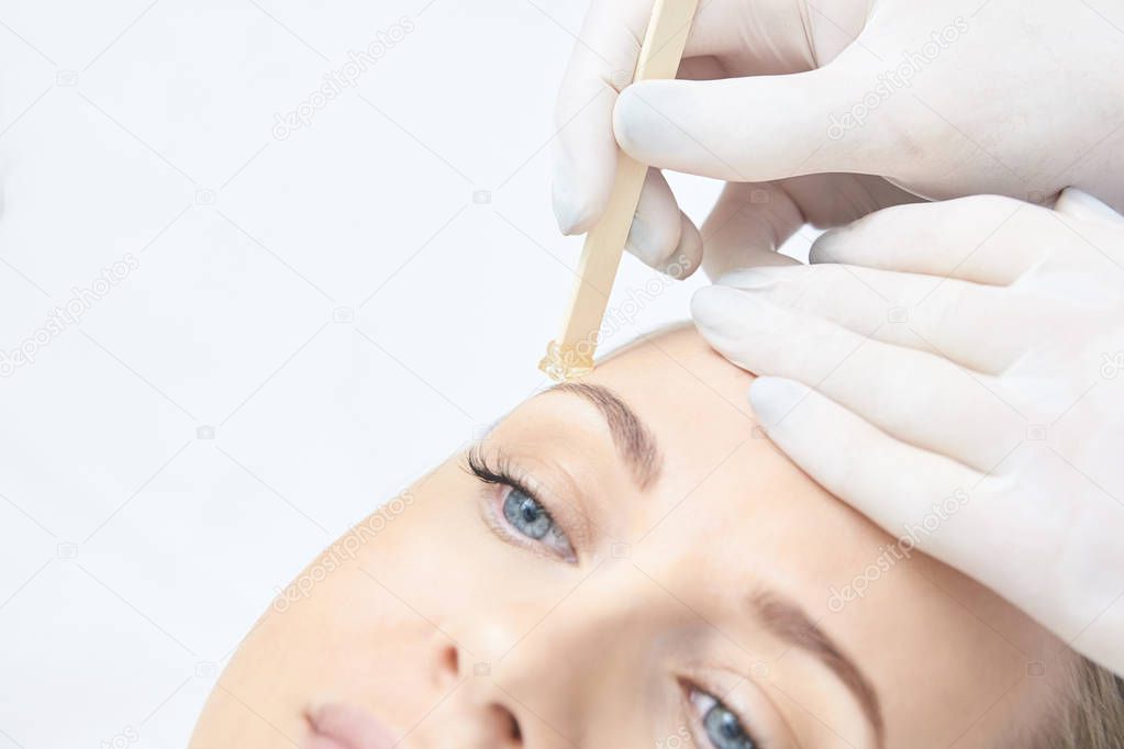 Waxing woman leg. Sugar hair removal. laser service epilation. Salon wax beautician procedure.