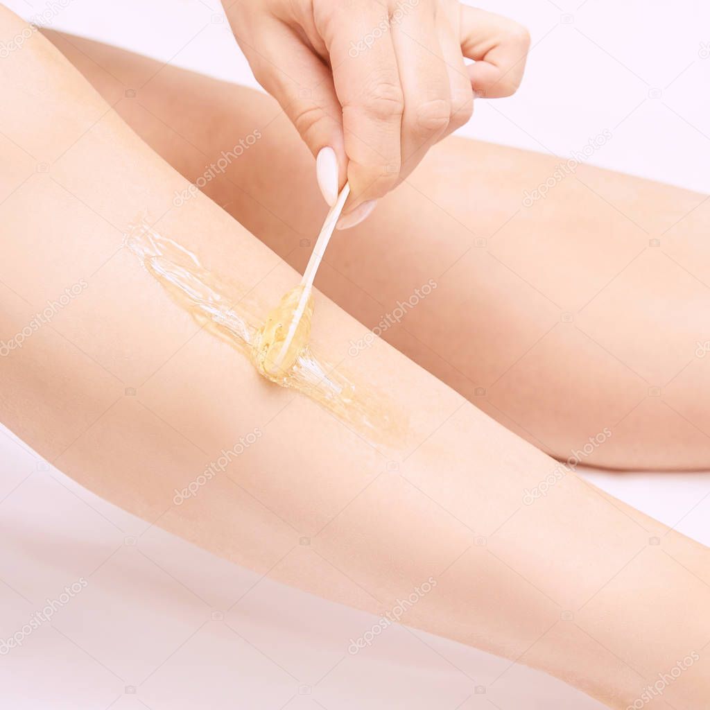 Depilation spa procedure. Woman hair remove waxing. Epilation sugaring. Legs foot. Self.