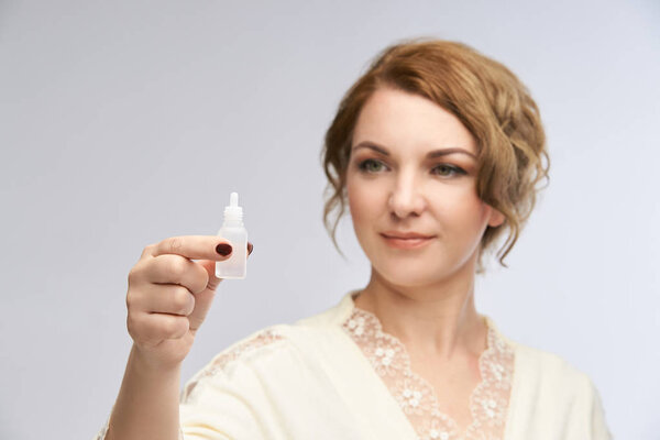 Woman apply eye drops. Girl glaucoma treatment.