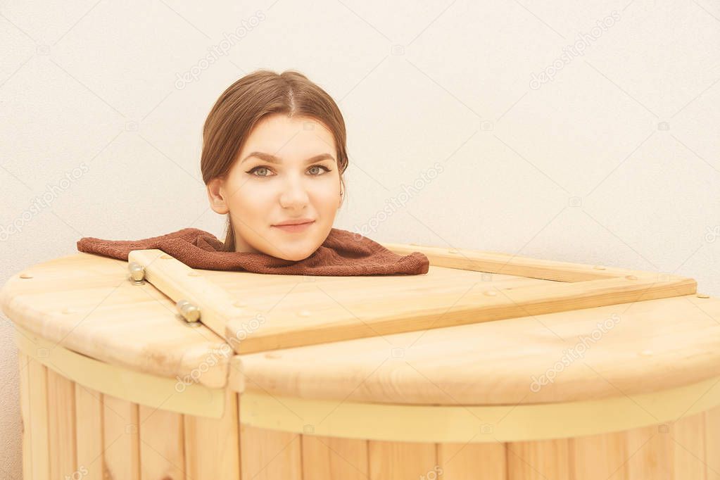Barrel cedar. Wellness spa sauna. Aromatherapy treatment. Young beauty woman. Girl face.