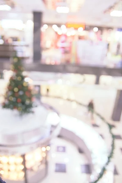 Bright interior. Blurred background. Shopping center. Christmas tree.