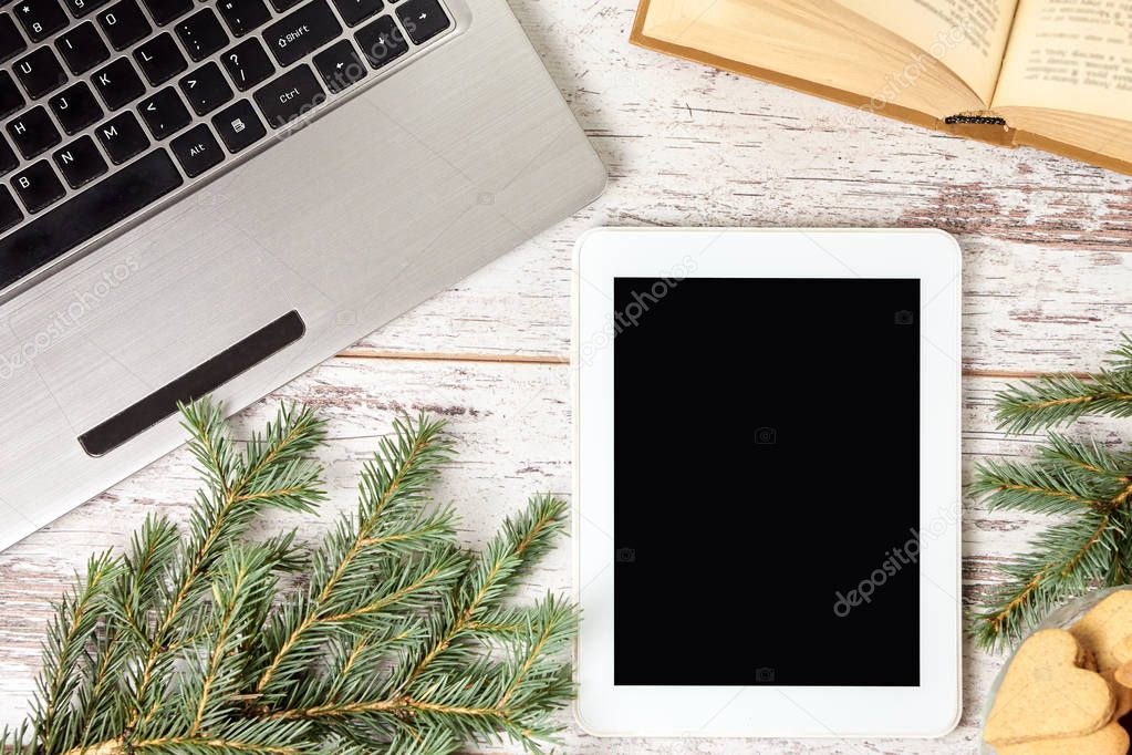 Computer tablet. Notebook. Green spruce branch.