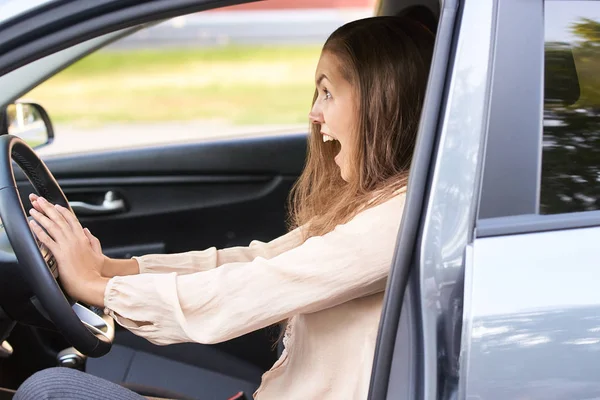 Young woman in car. Ride instruction accident. Automobile loan.