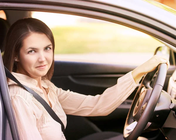 Young woman in car. Ride instruction. Automobile loan.