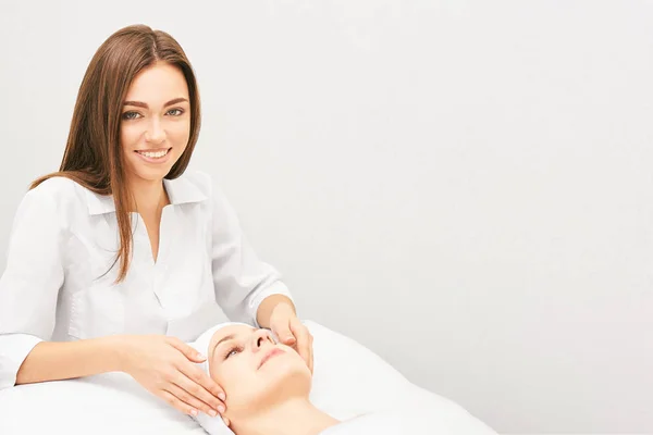 Face professional massage. Spa skincare treatment. Health facial masseur. Girl with doctor hands. Relax cosmetology procedure.