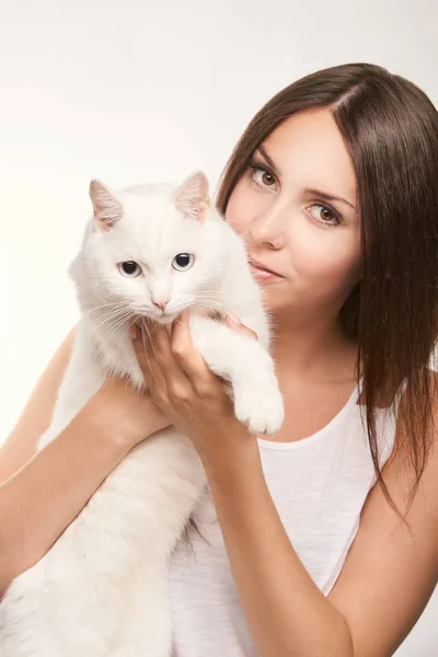 Young woman with white cat. Happy girl allergy animal. Veterinarian concept