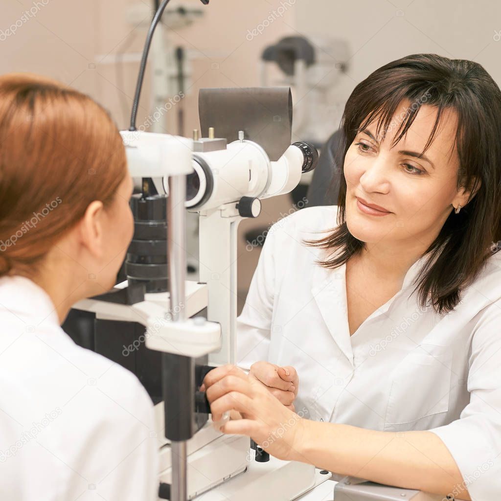 Eye ophthalmologist exam. Eyesight recovery. Astigmatism check concept. Ophthalmology diagmostic device. Beauty girl portrait in clinic