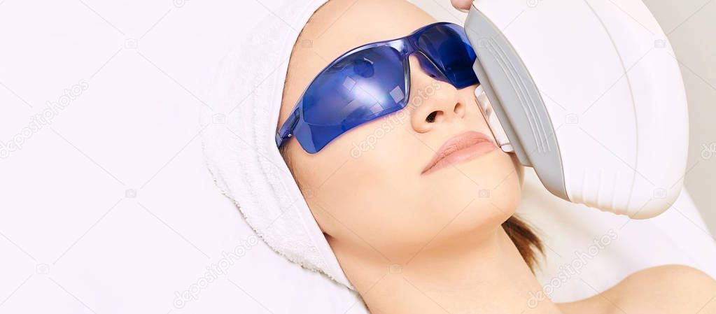 Laser facial hair removal. Cosmetology ipl device. Woman body in