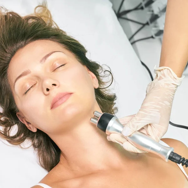 Dermatology skin care facial therapy. Medical spa anto wrinkles procedure. Woman face rejuvenation. Pretty girl. Rf cosmetician equipment. Chin and neck