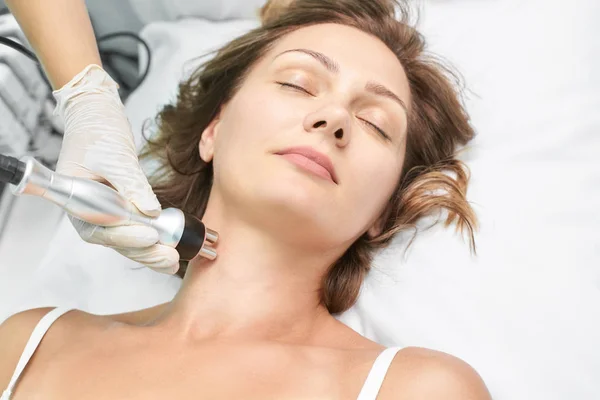 Dermatology skin care facial therapy. Medical spa anto wrinkles procedure. Woman face rejuvenation. Pretty girl. Rf cosmetician equipment. Chin and neck