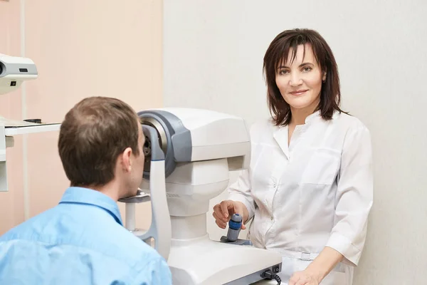 Eye ophthalmologist exam. Eyesight recovery. Astigmatism check concept. Ophthalmology diagmostic device. Beauty girl portrait in clinic. Man patient — Stock Photo, Image