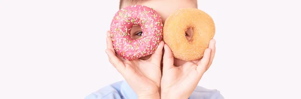 A boy with two doughnut. A place for text. Modern concept without a face — Stock Photo, Image